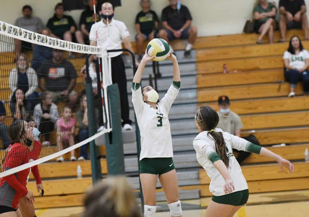 Volleyball player setting ball during a match at Madera Tribune event.