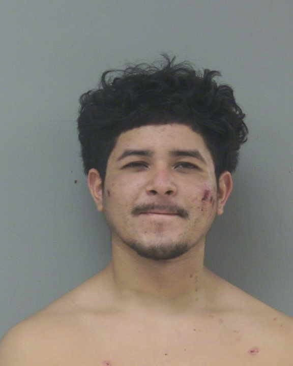 Madera Tribune young man mugshot with messy hair and facial acne.
