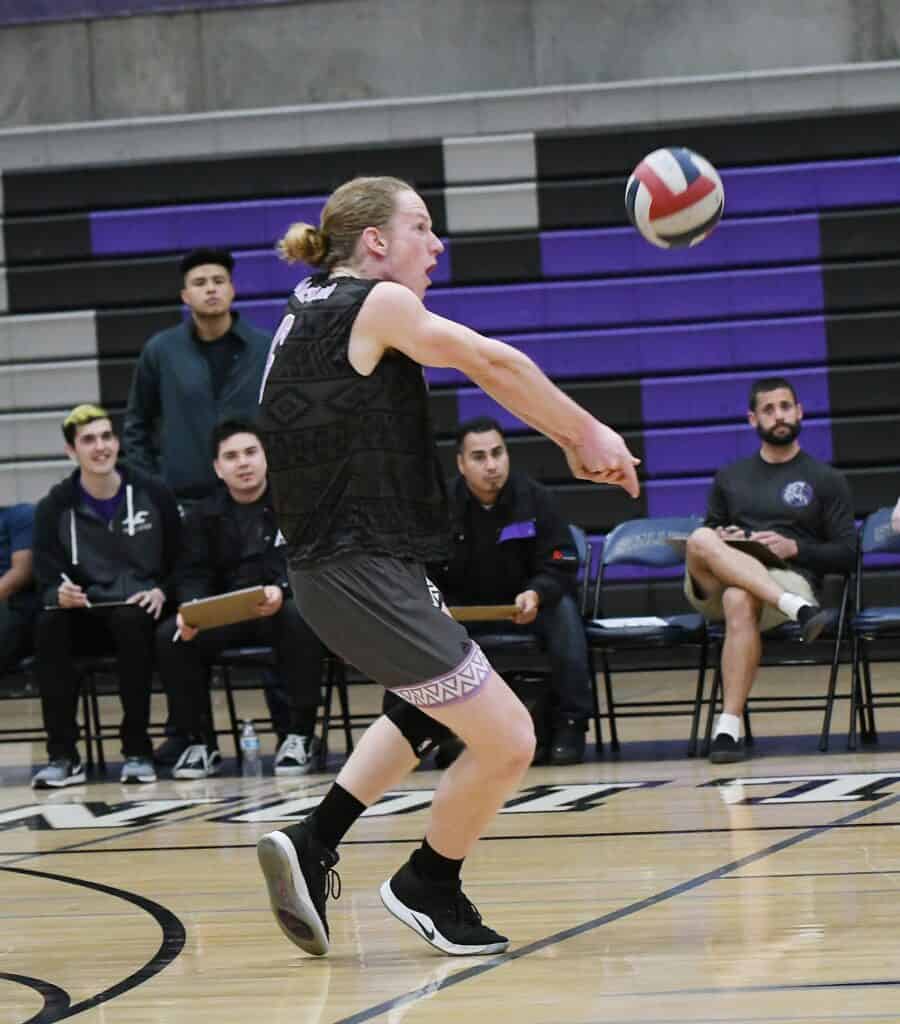 Female volleyball player hitting the ball during a match.