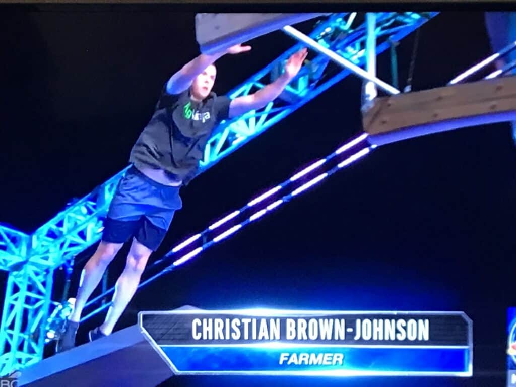 Christian Brown-Johnson performing at an event, showcasing athleticism and stage presence.