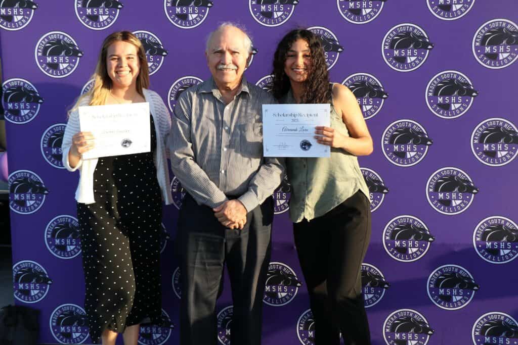 Two women and a man holding certificates at Madera Tribune event.