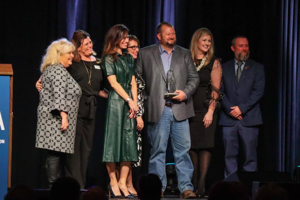 Group of people on stage at Madera Tribune awards event.