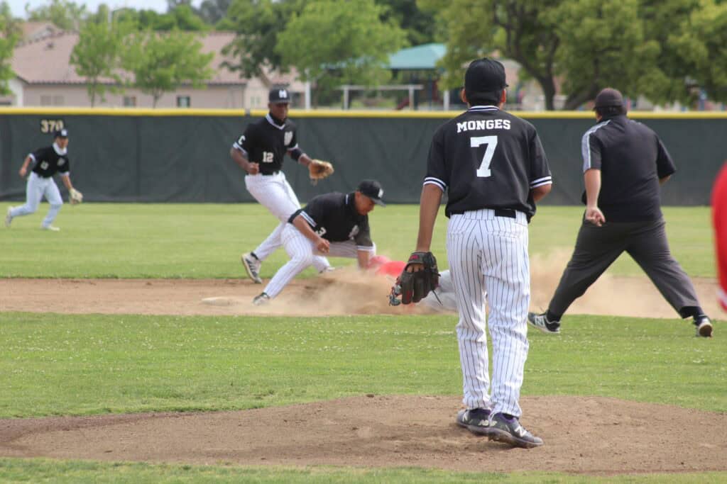 Madera baseball players in action on the field during a game.