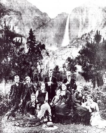 Historic group photo of early settlers in Madera County with Yosemite Falls in the background.