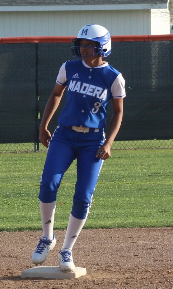 Madera high school baseball player running on the field in uniform.