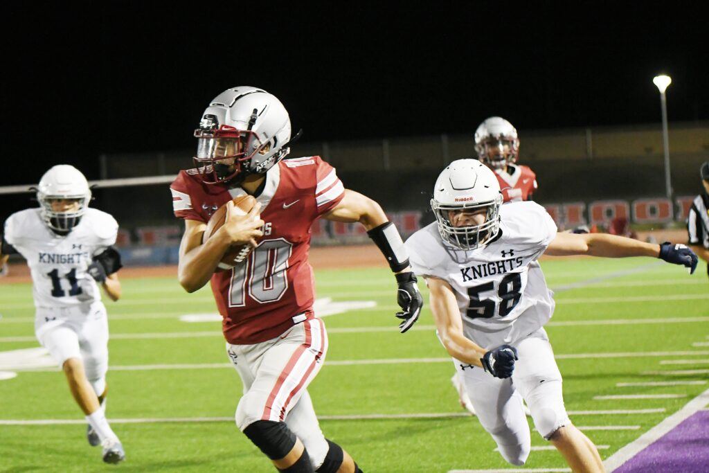 Photo - Matilda Torres quarterback Jose Soriano runs past a Stone Ridge Christian defender down the sideline during Friday’s victory — the first home win in school history.