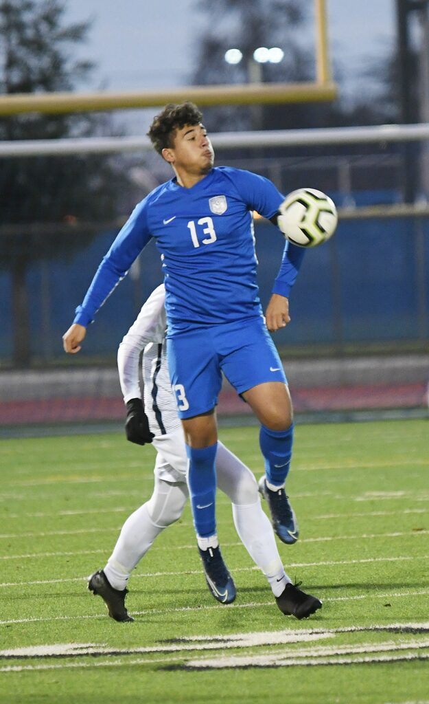 Madera midfielder Miguel Gutierrez tries to keep control and possession of the ball during Friday’s victory over San Joaquin Memorial. The win in Memorial Stadium gave the Coyotes their third straight victory.