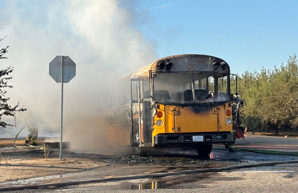 Photo - Cal Fire firefighters put out a blaze on a Madera Unified School District bus Thursday morning. The bus was carrying students to school, but all of the students and driver evacuated the bus and no injuries were reported.