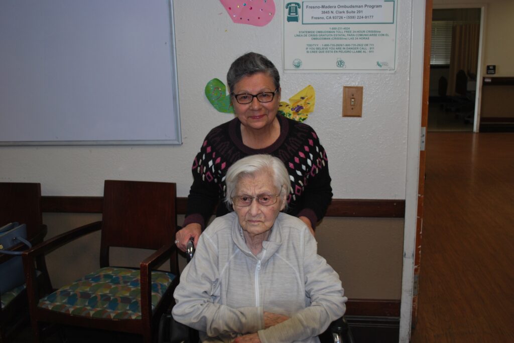 Photo - One-hundred-three-year-old Lupe Valdez Pico, joined by her daughter-in-law Connie Palacios Pico, on their way to Lupe’s birthday celebration held recently at Avalon Health Care Center on Howard Road.