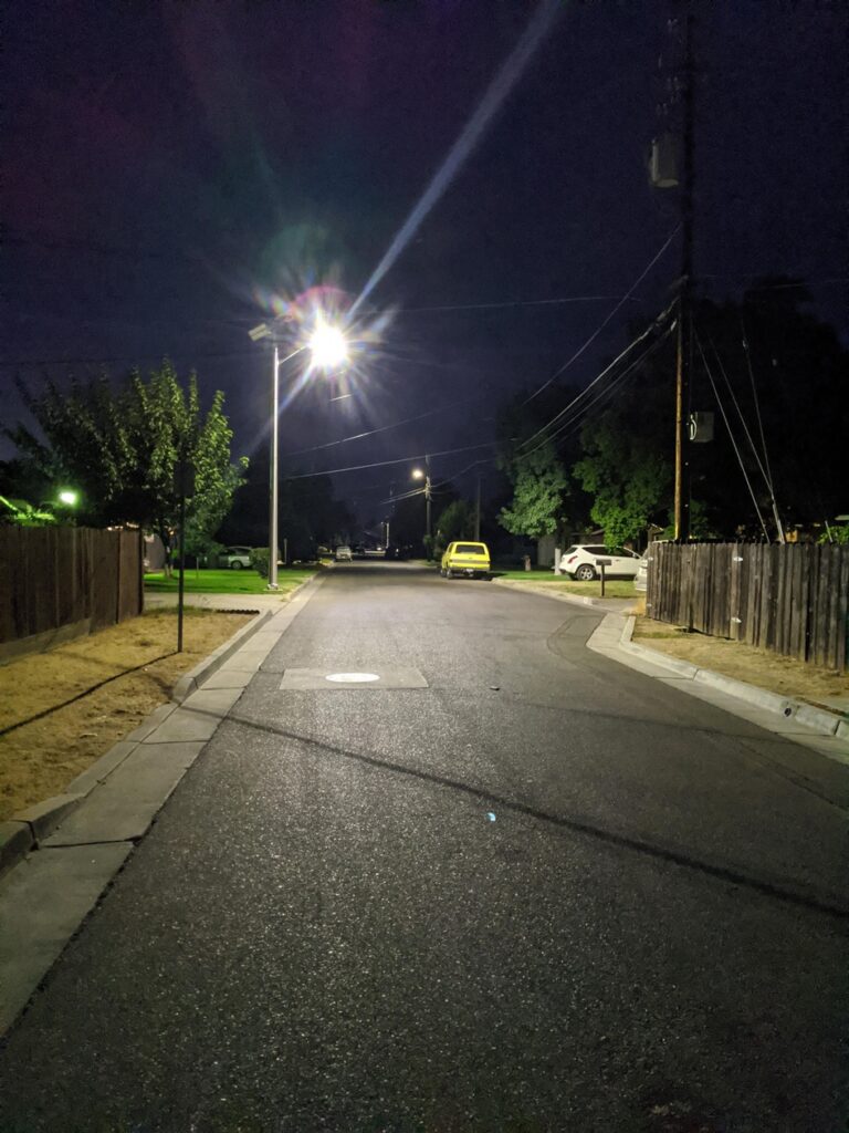 Photo - A new solar street light brightens up the street as a part of an $18 million project to improve city streets.