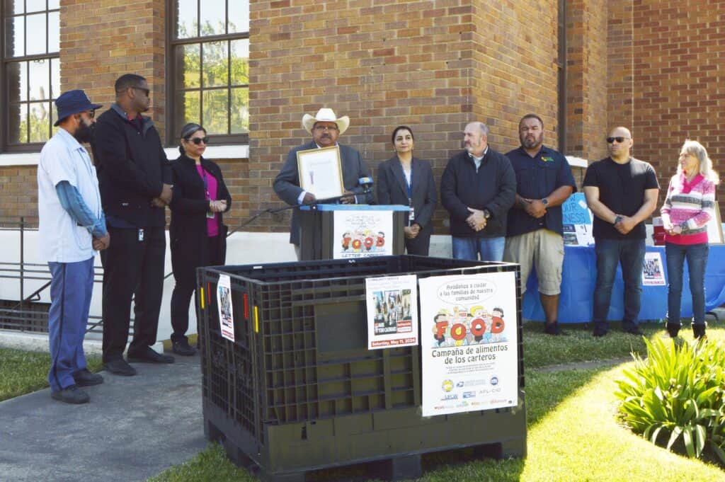 Community members gather for food drive outside Madera Tribune office.