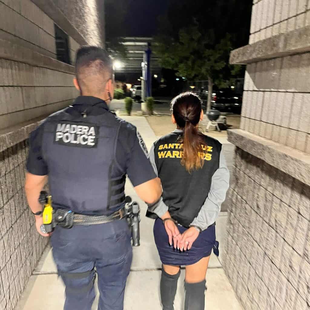Madera police officer and Santa Cruz warnings officer walking at night.