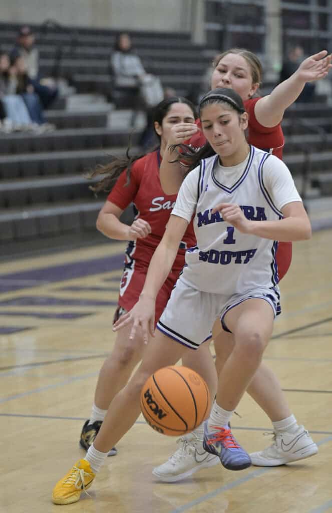 Photo of Madera South’s Chloe Robinson tries to turn the corner in the lane Tuesday against the Sanger Apaches. Robinson scored five points in the 63-25 loss.
