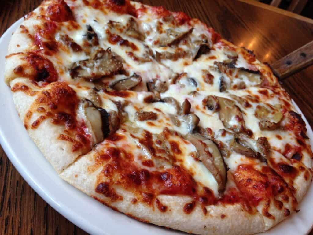 Mushroom pizza with melted cheese and crispy crust, served hot and fresh. Perfect for pizza lovers a.
