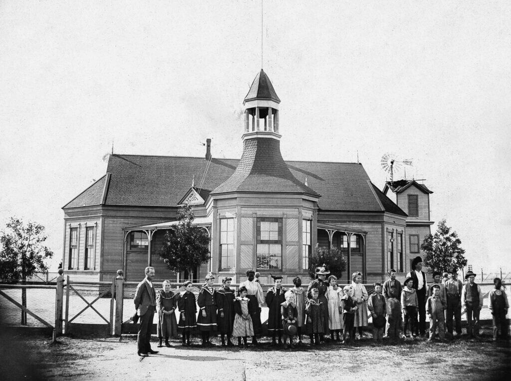 Historic Madera County courthouse with community gathering.