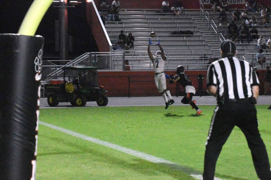 Madera High School football player catches the ball in end zone.