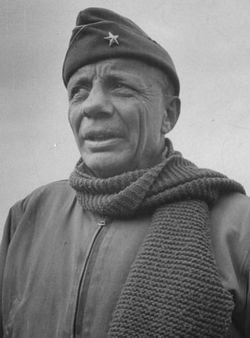 Historic photo of a man in military uniform with a star cap.