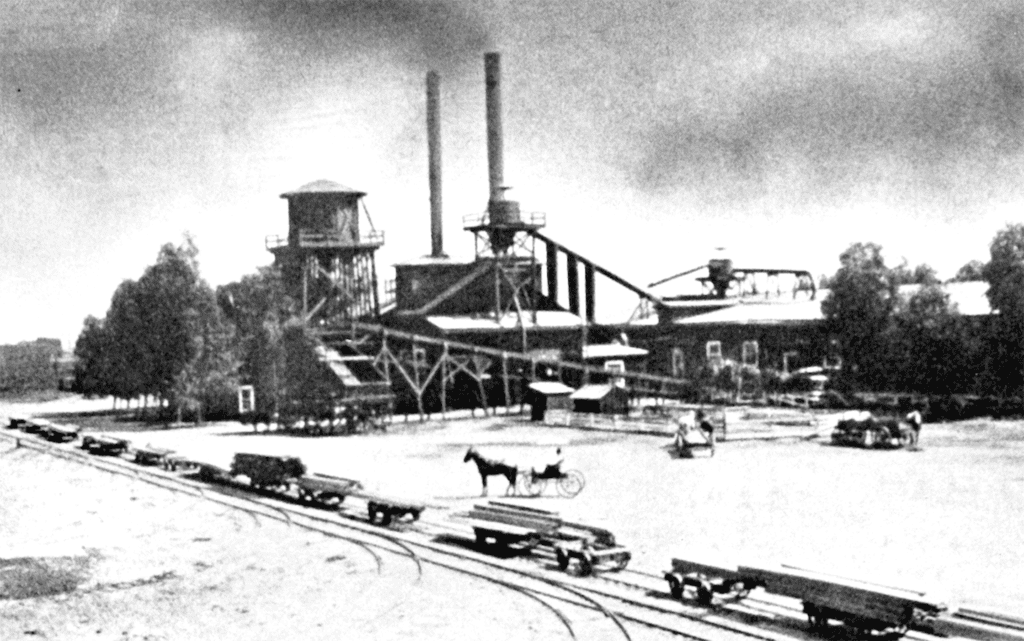 Madera Railroad and Industry scene with trains and factory buildings in black and white.