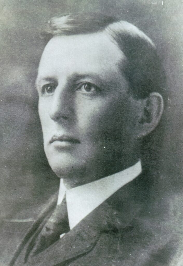 Portrait of a young man in early 20th-century attire.