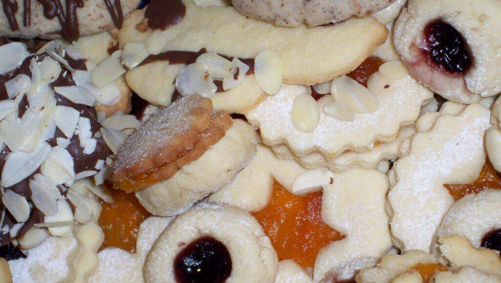Delicious assortment of holiday cookies with jam, chocolate, and almond toppings. Perfect for Christ.