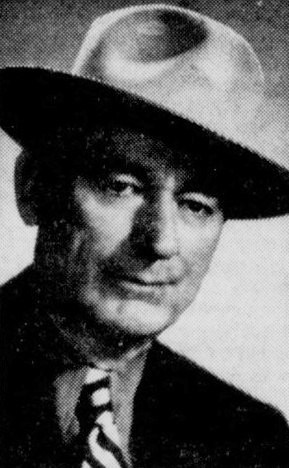 Historic photo of a man wearing a hat and suit.