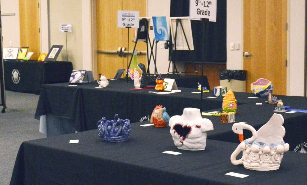 Art contest display showcasing student artwork from local schools.
