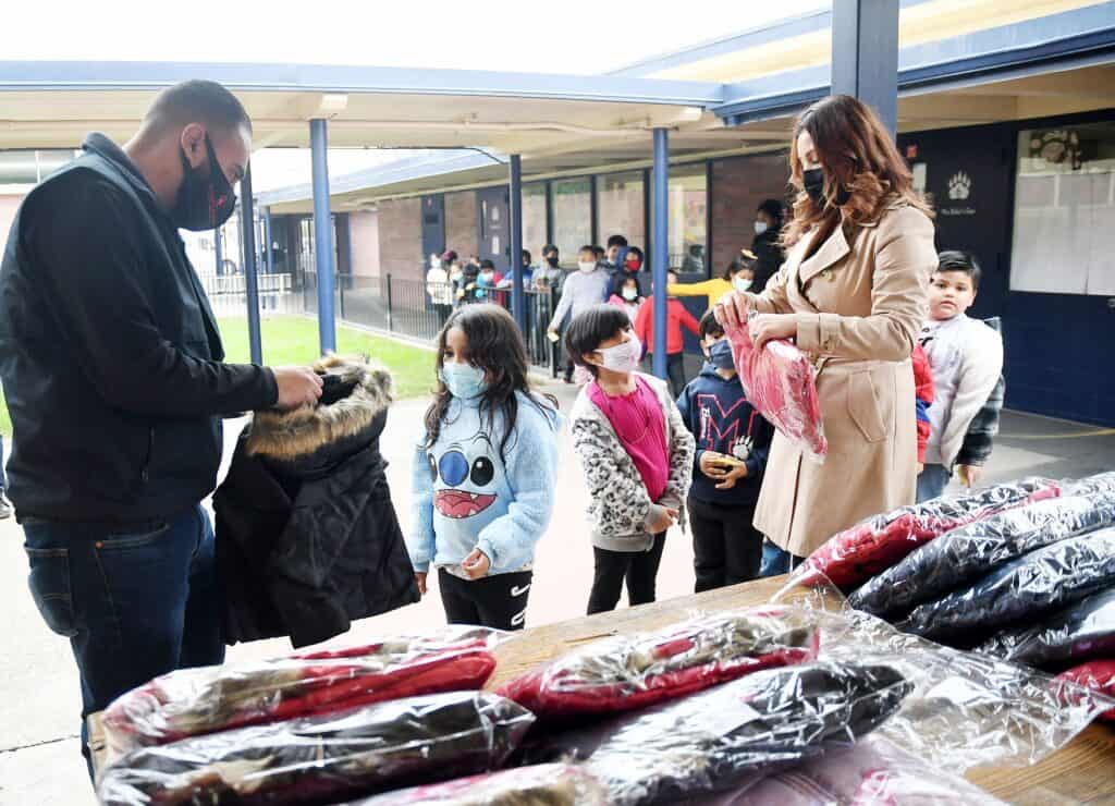 People wearing masks at clothing giveaway event in Madera.
