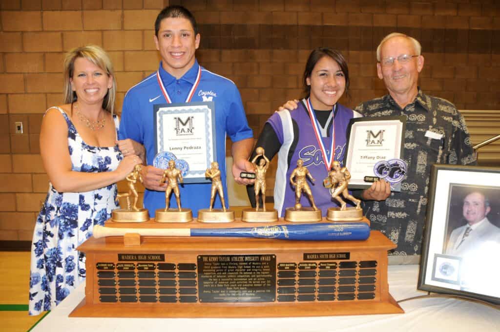 Students receiving awards at Madera Tribune event with trophies and certificates.