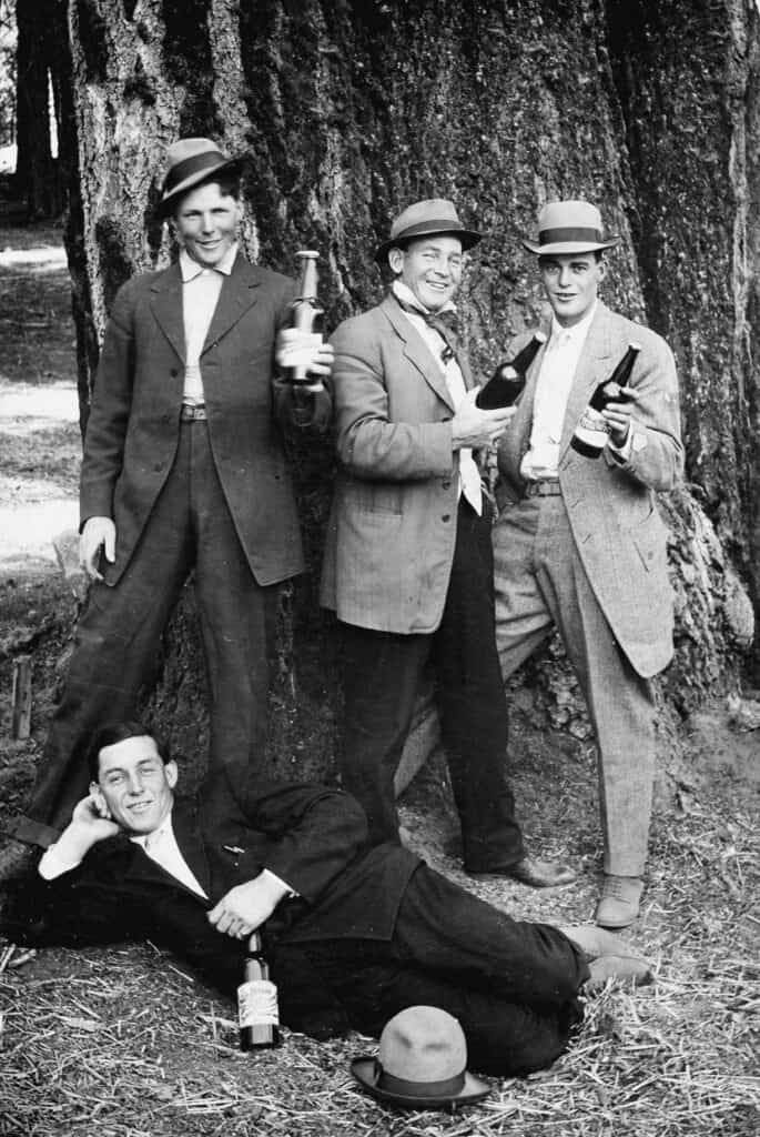 Vintage women and man enjoying drinks outdoors.