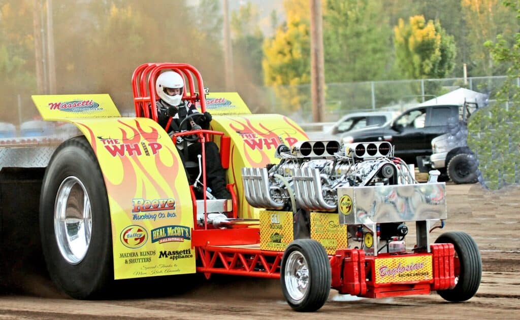 Drag racing car at Madera Raceway event, showcasing high-performance engine and vibrant yellow and r.