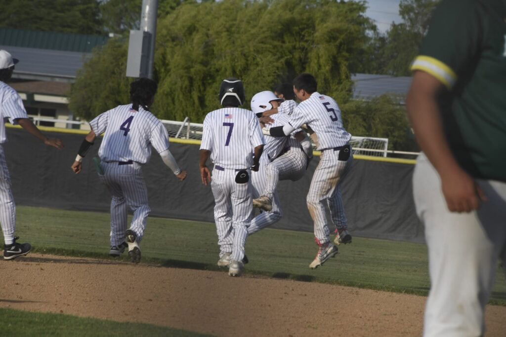 Celebrating a baseball victory with team huddle and high-fives.