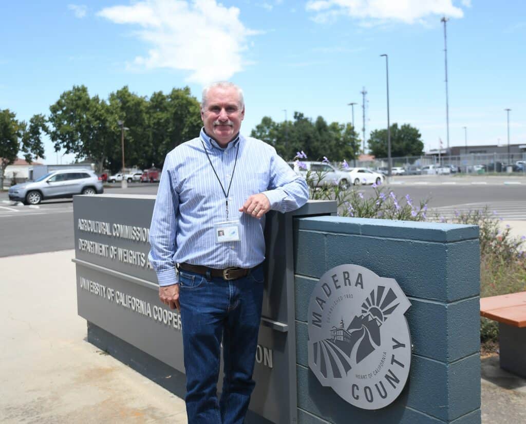 Madera County official standing outside the Department of Welfare building.