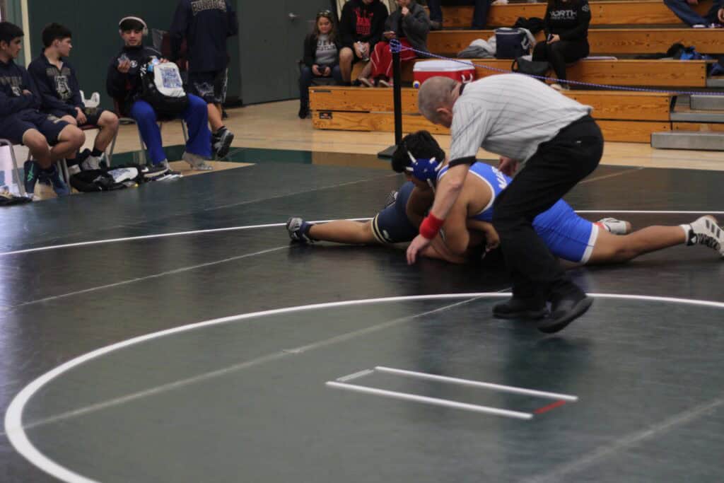 Youth wrestling match at Madera high school gymnasium.