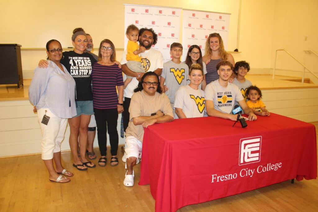 Group photo of diverse students and adults at Fresno City College event.
