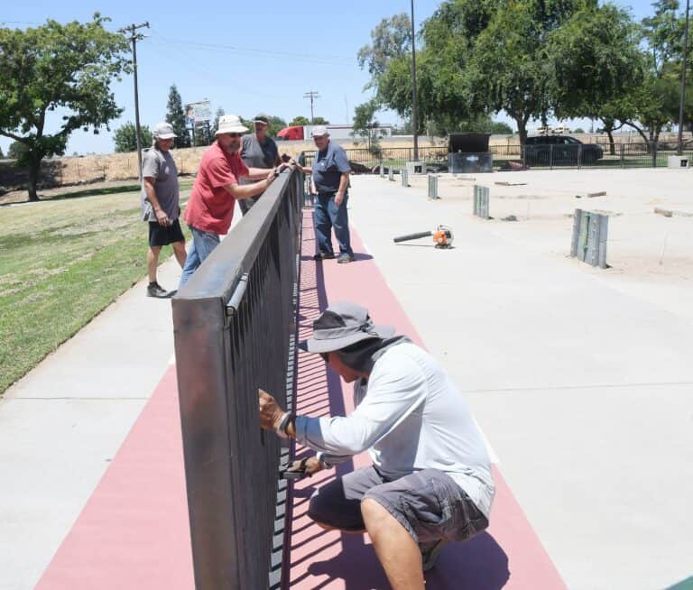 Horseshoe league paints park fences