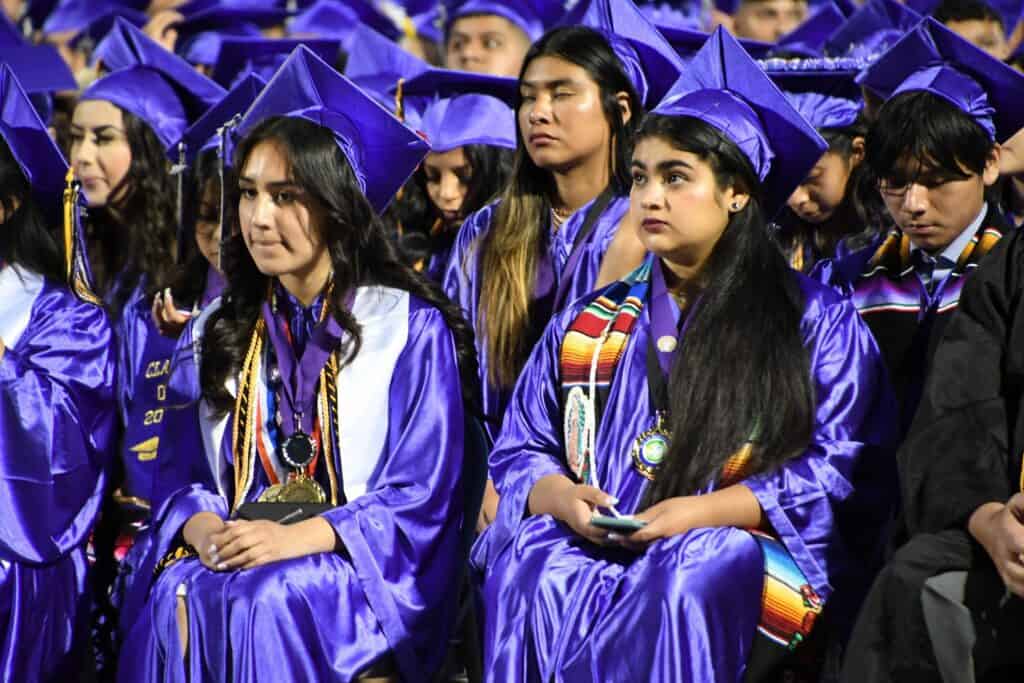 Students in blue caps and gowns at Madera High School graduation.