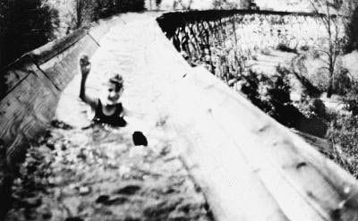 Child sliding down a water slide in Madera County, California.