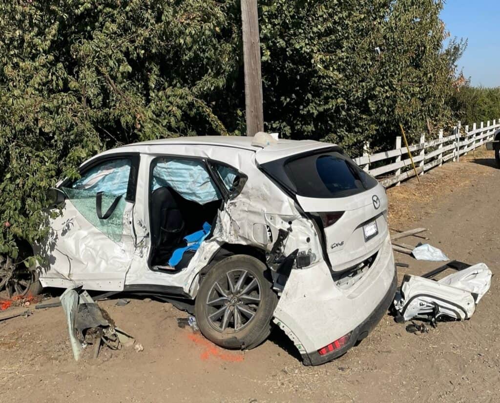 Car accident with a damaged white vehicle after crash.