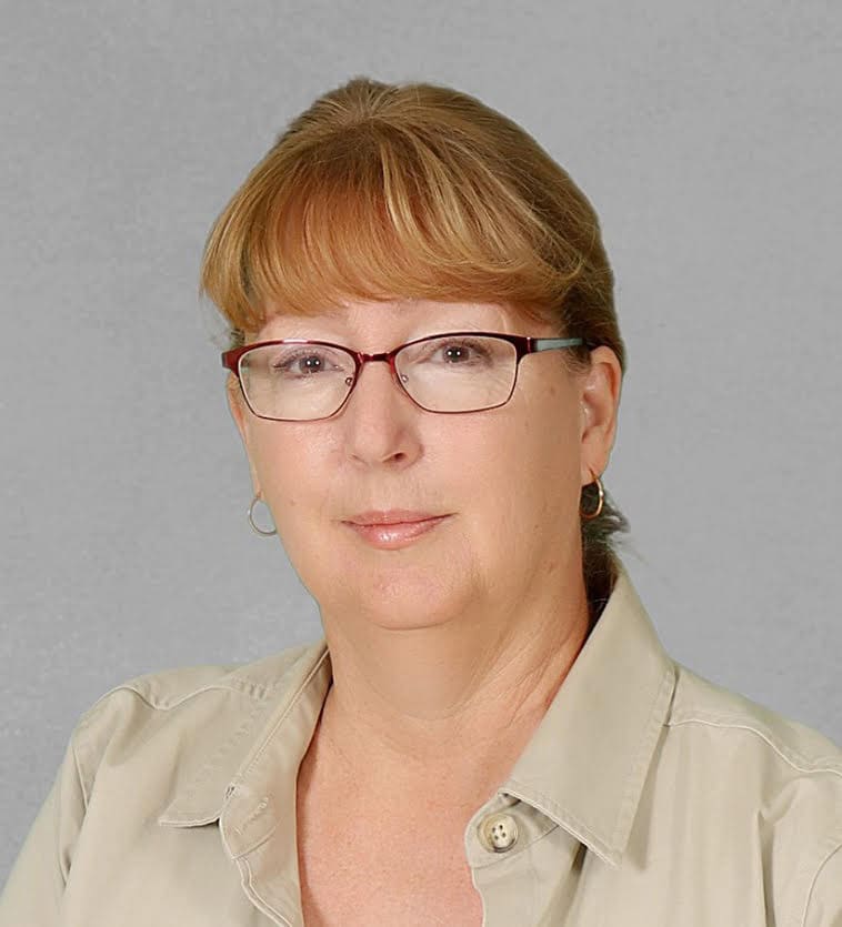 Woman wearing glasses in a professional portrait.