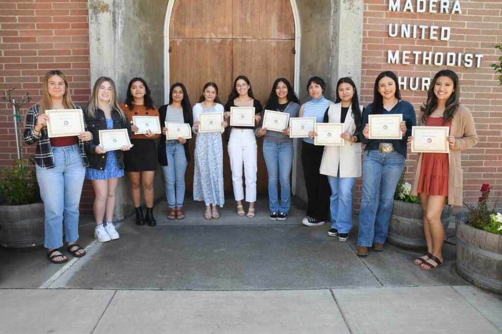 Madera UMC youth group holding certificates outside the church.