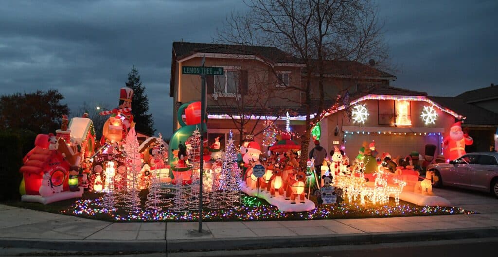 Christmas holiday lights display with inflatables and decorations in Madera neighborhood.