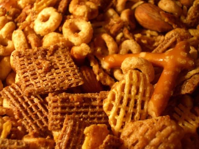 Snack mix with cereal, nuts, and pretzels for a tasty treat.