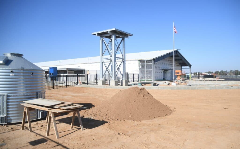 Construction site at Madera County Fairgrounds with new building in progress.