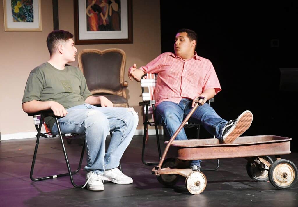 Young actors in a community theater play, engaging in a lively scene on stage.