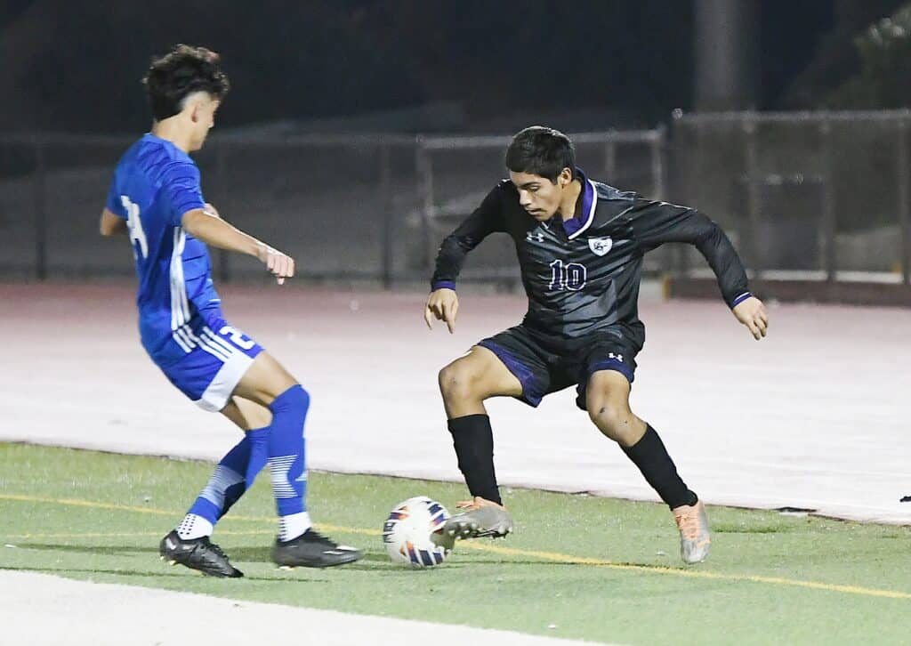 Youth soccer players competing on the field during a game.