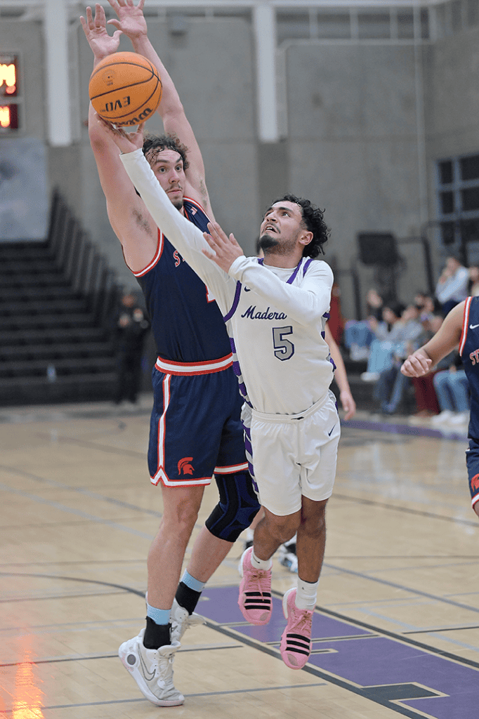 Two players competing for the basketball during a game.
