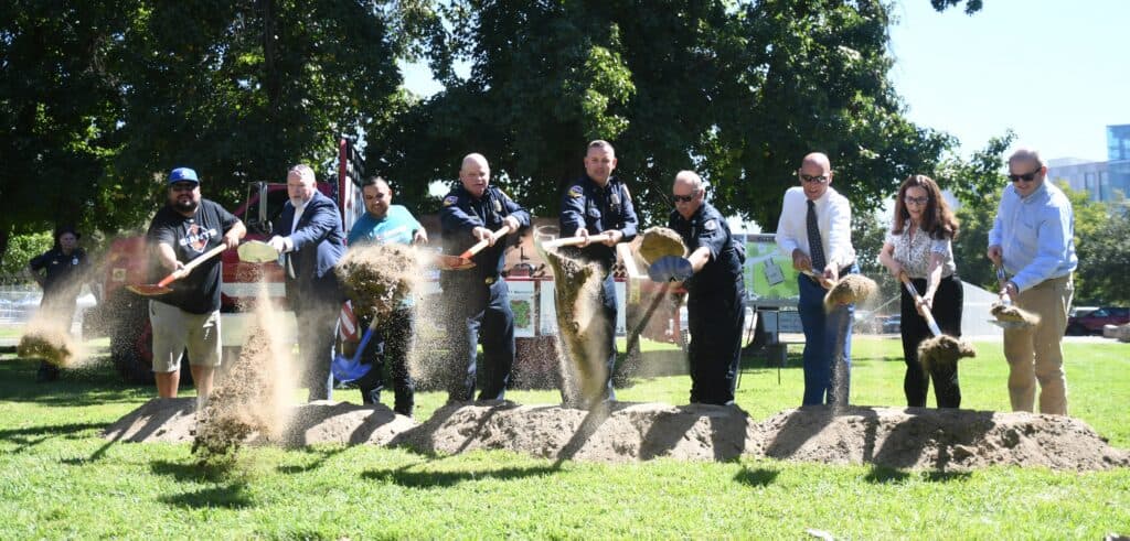 Group of people participating in a groundbreaking event at Madera Park.
