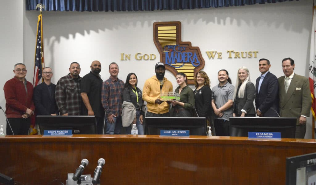Madera city officials and community members at city council meeting.
