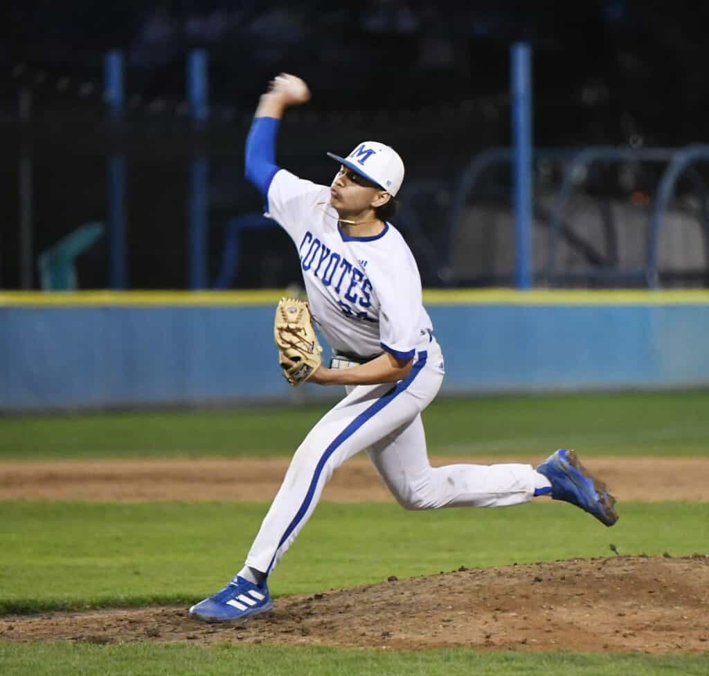 Young baseball pitcher in action on the field.