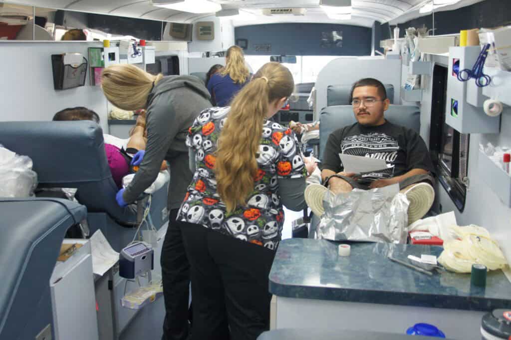 Blood donation in progress at a mobile blood drive.